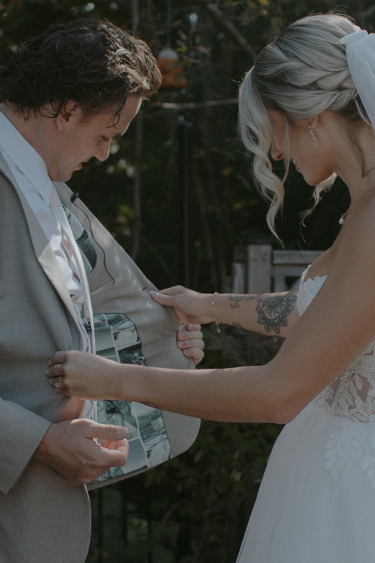 The woman open the jacket of the man and see the custom picture collage suit lining.