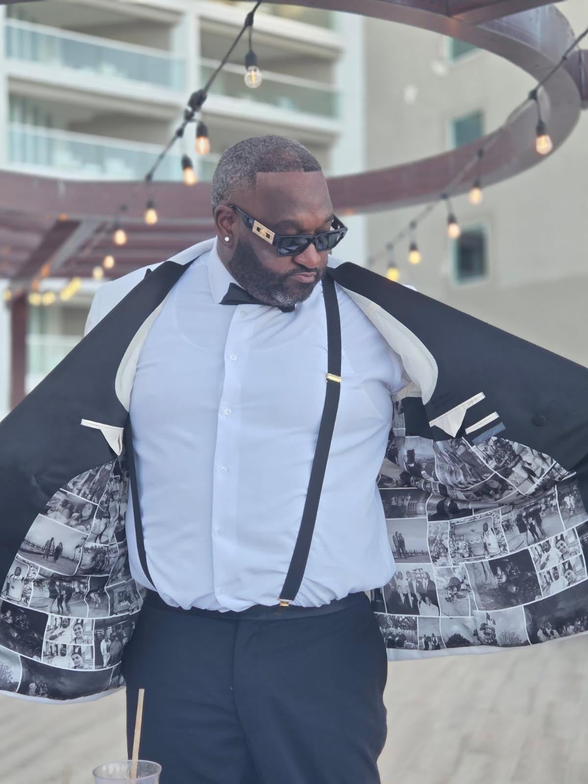 Man opening his jacket and display the custom pictures collage suit lining. In front of a buidling.