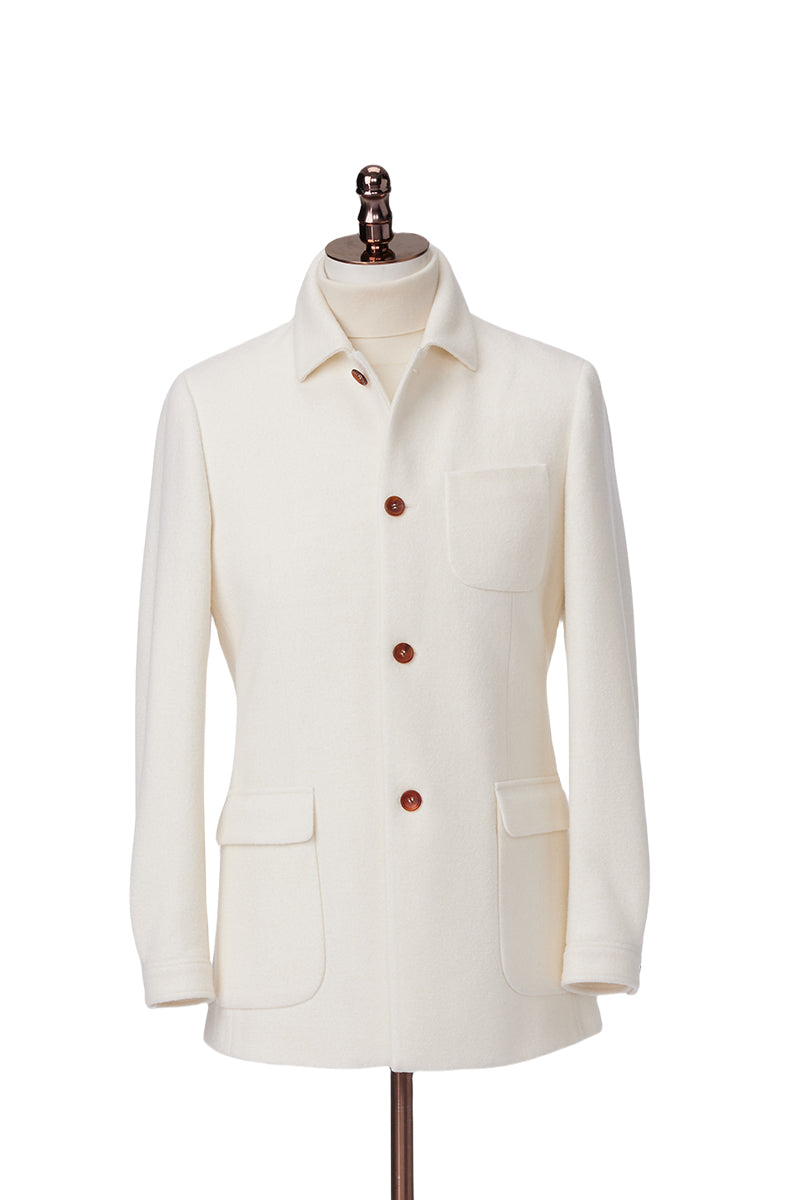 White jacket with brown buttons on a mannequin against a white background