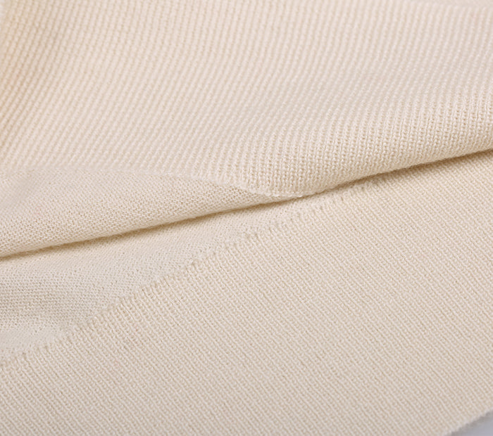 Close-up of beige cashmere fabric with a subtle pattern