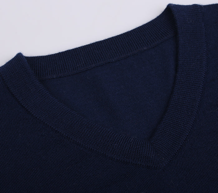 Close-up of a navy blue sweater collar on a white background