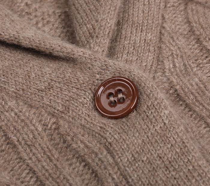 Close-up of a brown button on a cashmere cardigan