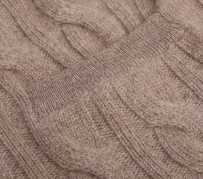 Close-up of a cable knit cashmere cardigan in a neutral color