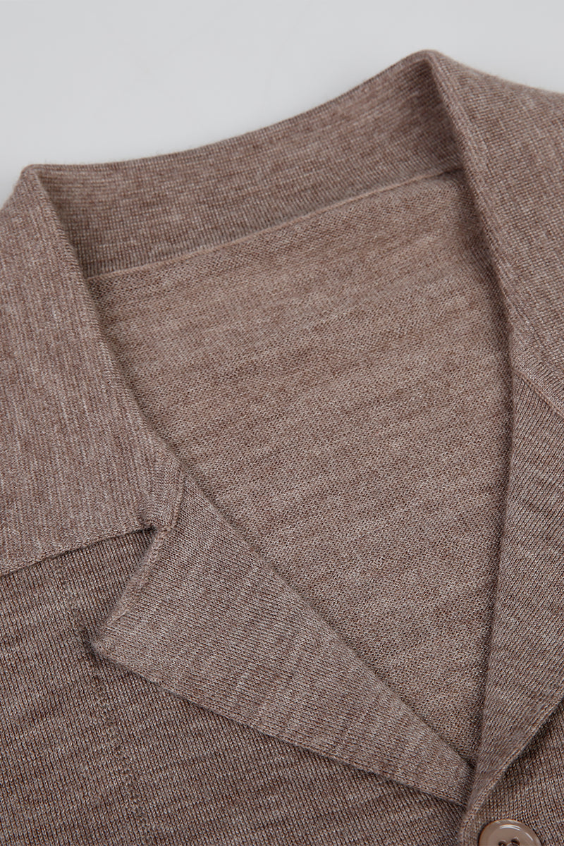 Close-up of a brown textured fabric garment on a light gray background