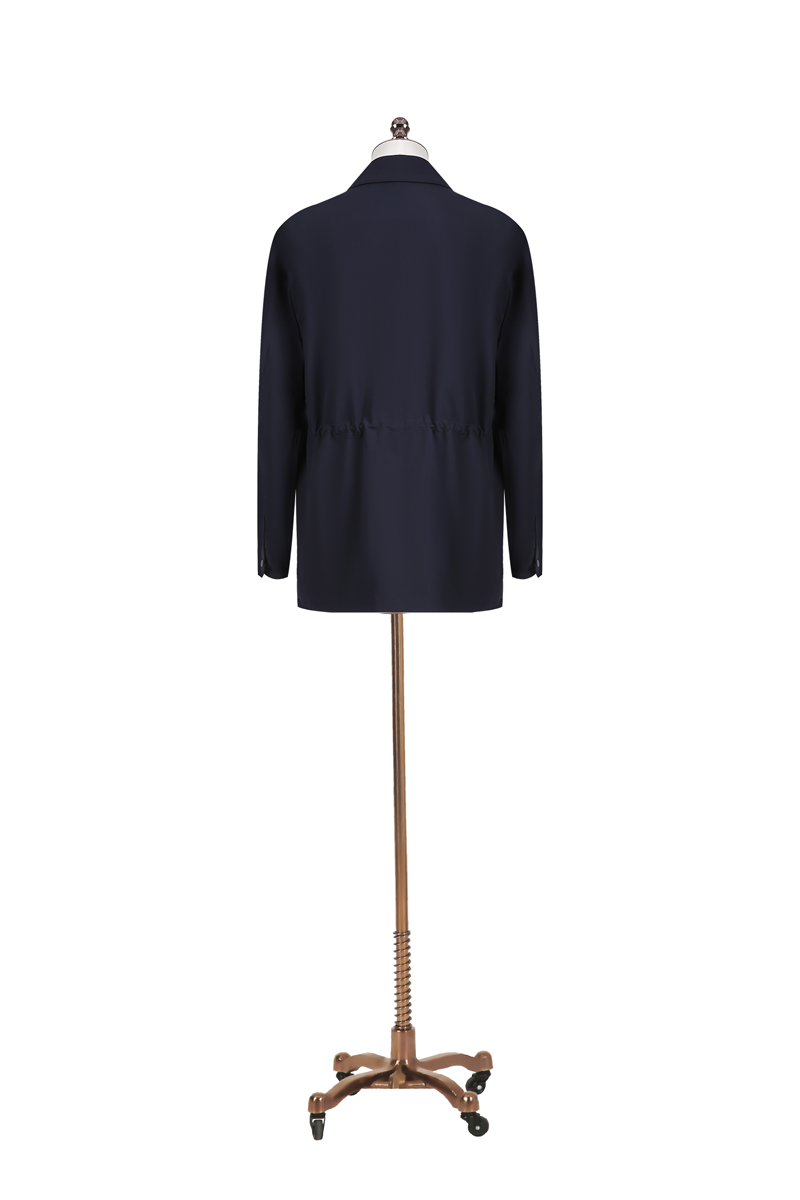 Navy blue coat on a mannequin with a decorative base against a white background