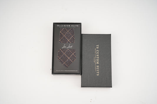 Two gray boxes with a patterned tie design and 'TS Custom Suits' branding on a white background.