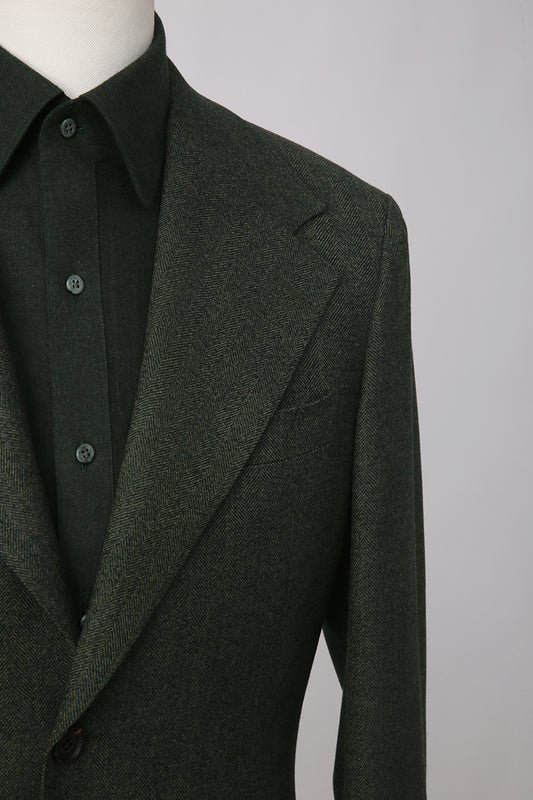 Dark gray blazer on a mannequin against a plain background