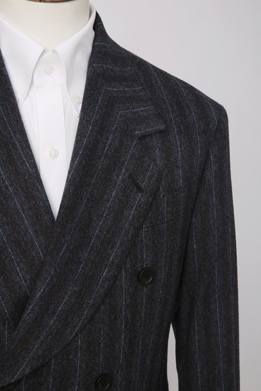 Dark gray pinstripe suit jacket on a mannequin with a white shirt underneath.