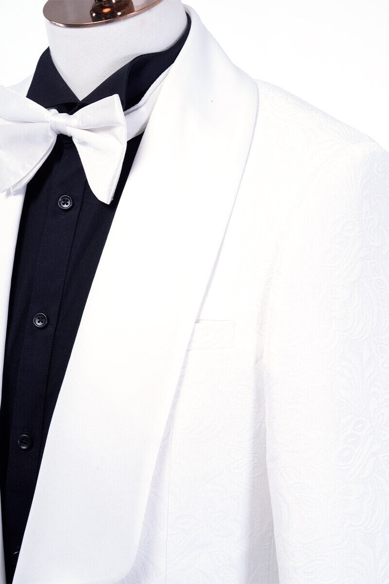 White shawl lapel embroidered tuxedo with black pants. White wedding tux. White shawl lapel tuxedo. Satin covered buttons and satin shawl lapel on this beautifully embroidered white wedding tuxedo. Perfect wedding tux for groom.