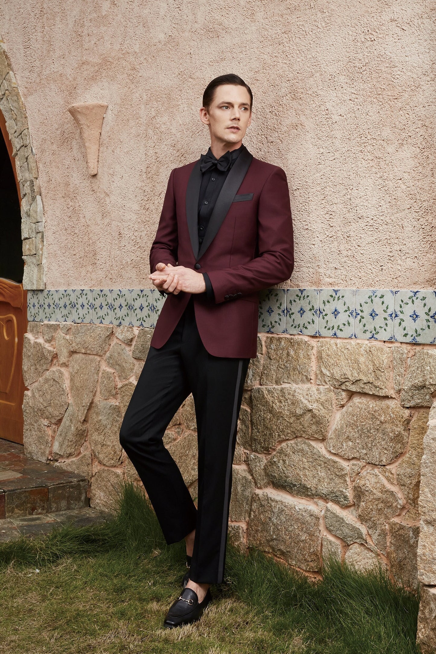 Burgundy tuxedo jacket with black satin shawl lapel. Burgundy vest and pants pictured. Burgundy wedding tuxedo. Groom burgundy suit. Maroon wedding tuxedo. Maroon tux. Burgundy wedding tuxedo. Maroon wedding tux. Formal burgundy tux.