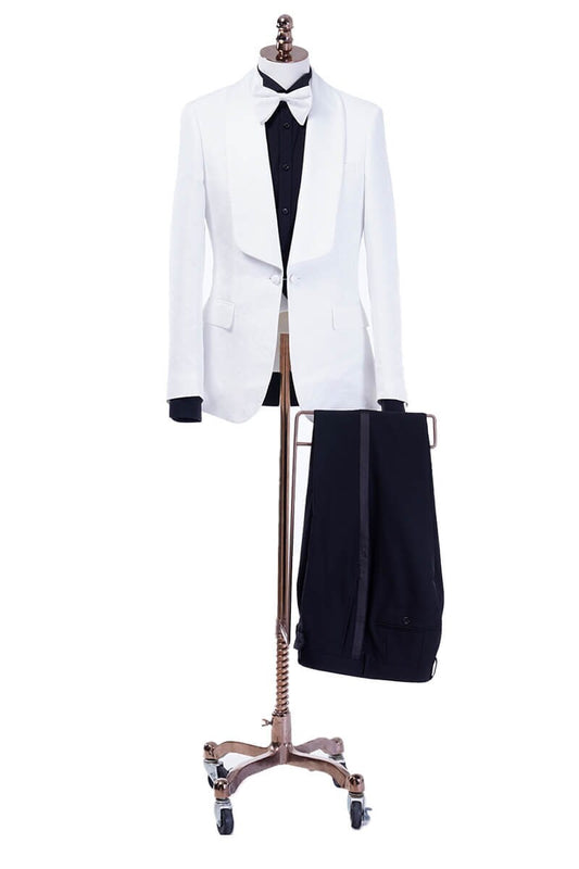 White shawl lapel embroidered tuxedo with black pants. White wedding tux. White shawl lapel tuxedo. Satin covered buttons and satin shawl lapel on this beautifully embroidered white wedding tuxedo. Perfect wedding tux for groom.