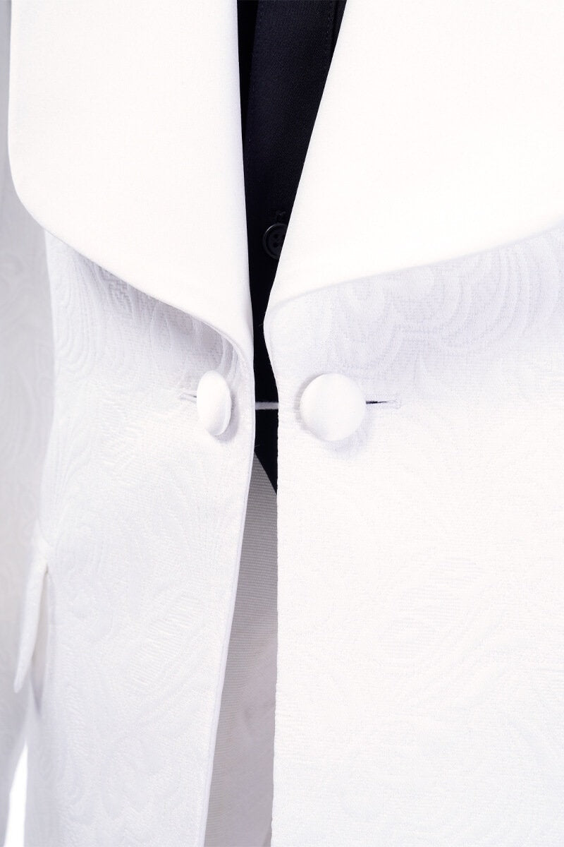 White shawl lapel embroidered tuxedo with black pants. White wedding tux. White shawl lapel tuxedo. Satin covered buttons and satin shawl lapel on this beautifully embroidered white wedding tuxedo. Perfect wedding tux for groom.