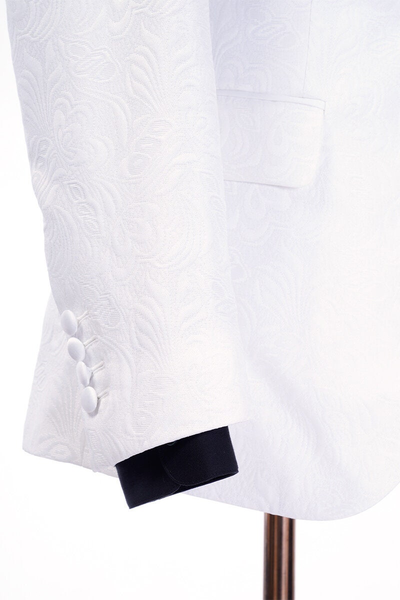White shawl lapel embroidered tuxedo with black pants. White wedding tux. White shawl lapel tuxedo. Satin covered buttons and satin shawl lapel on this beautifully embroidered white wedding tuxedo. Perfect wedding tux for groom.