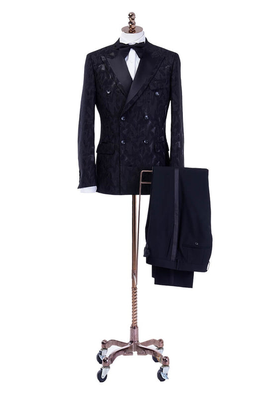 Embroidered black double breasted wedding tuxedo with peak lapels. Peak lapel tuxedo with black satin accents. Solid black pants with black satin stripe down the side. Black wedding tuxedo. Wedding tux for groom. Groom black wedding tuxedo.