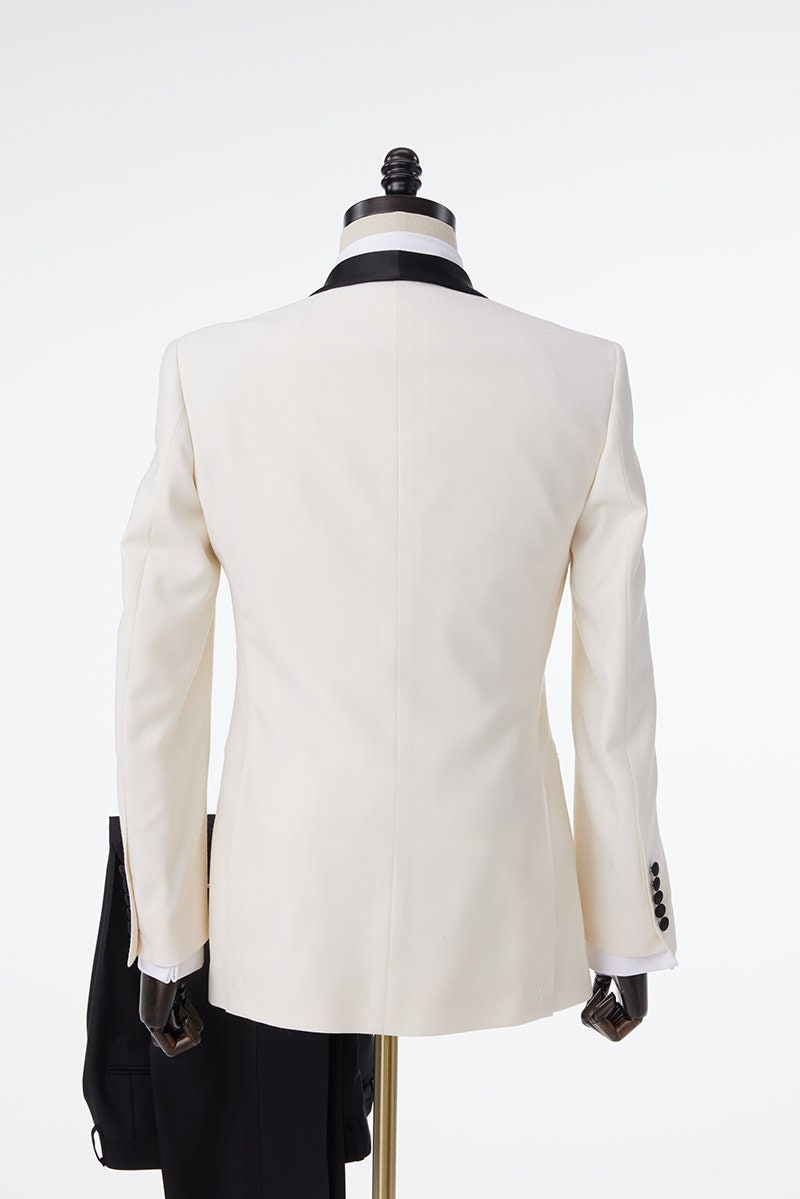 Ivory tuxedo with black shawl lapel. ivory wedding tuxedo. ivory off-white wedding tuxedo with black pants and a black satin accent stripe. Black satin lapel, satin covered buttons, black satin pocket accents on this ivory wedding tuxedo.