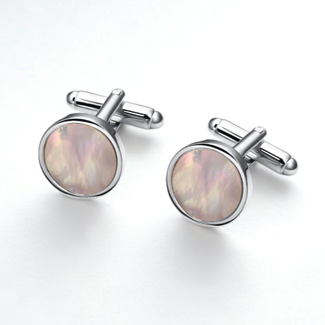 Cufflinks with round, iridescent gemstones on a white background