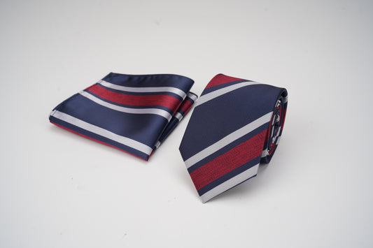 Navy, red, and white striped tie and pocket square on a light gray background