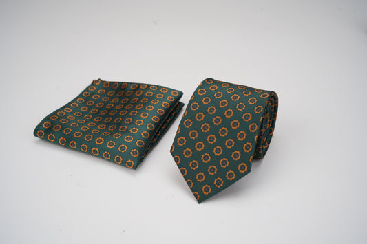 Green patterned tie and pocket square on a white background