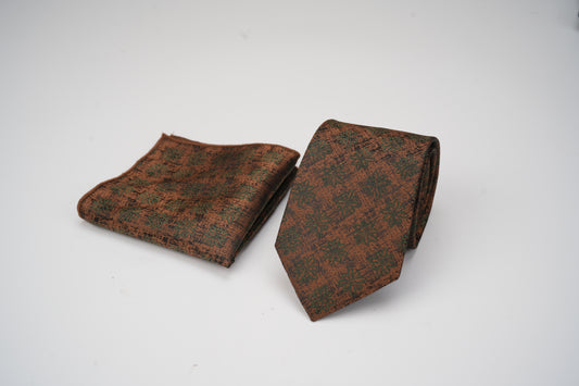 Brown patterned tie and pocket square on a white background