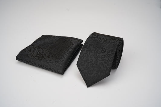 Black patterned tie and pocket square on a white background
