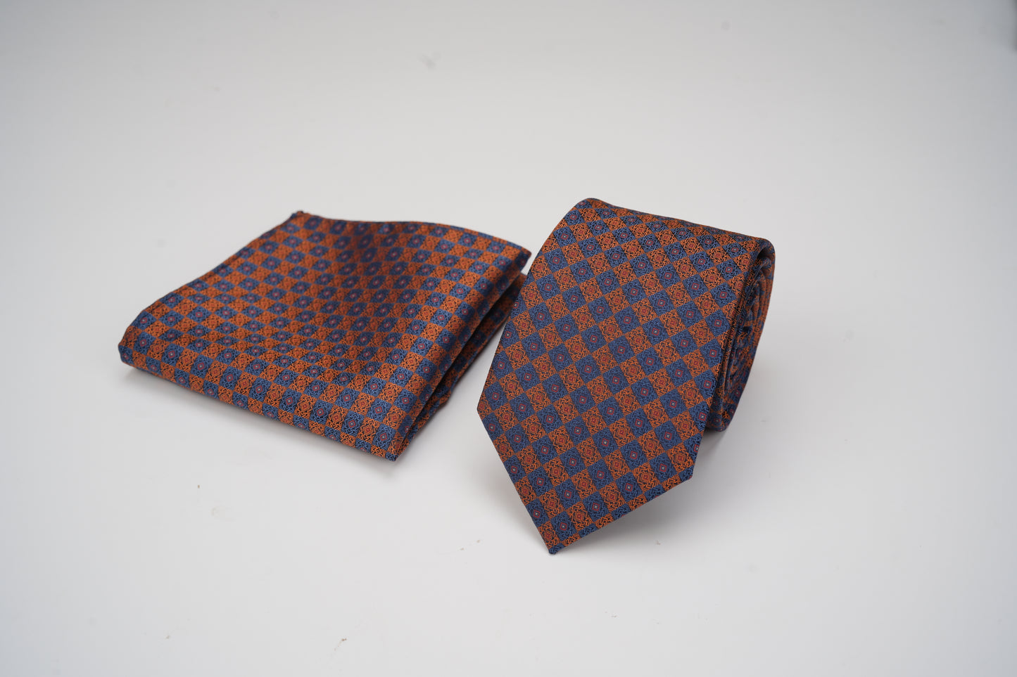 Patterned tie and pocket square set on a white background