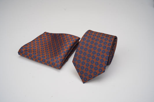 Patterned tie and pocket square set on a white background