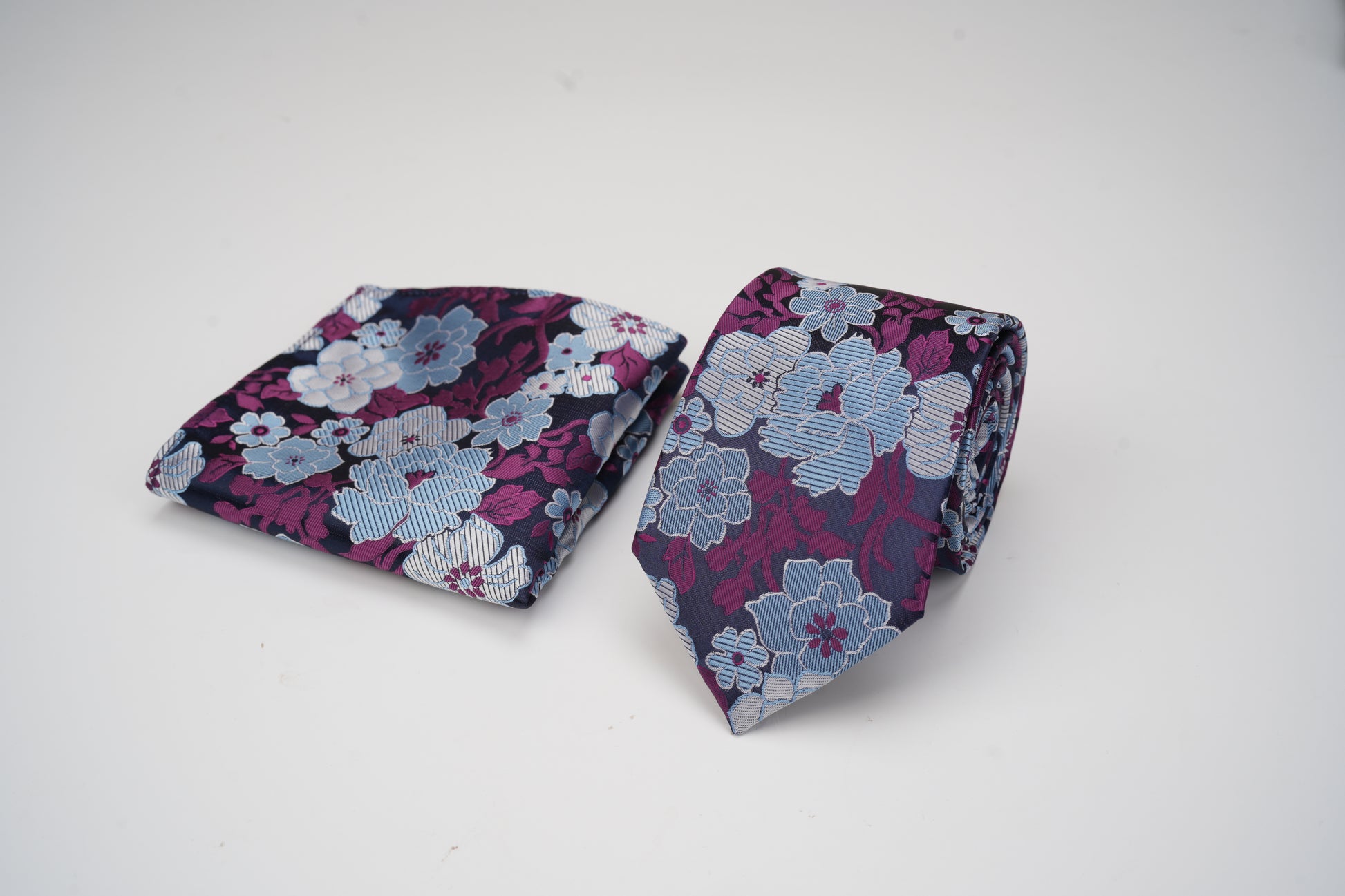 Floral-patterned tie and pocket square on a white background