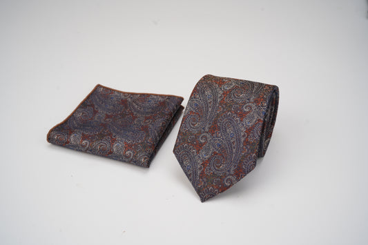Pair of brown paisley tie and pocket square on a white background