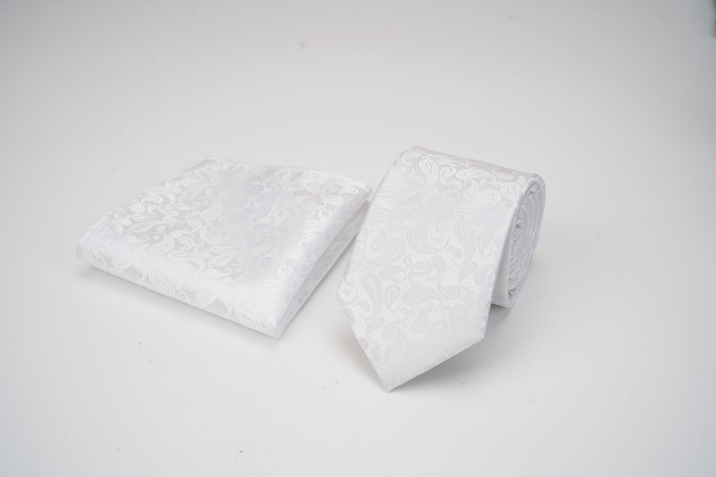 Two white pillows with textured surface on a light gray background