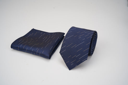 Navy blue tie and matching pocket square with white pattern on a light gray background