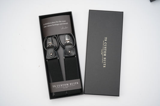 Black suspenders in a branded box on a white background