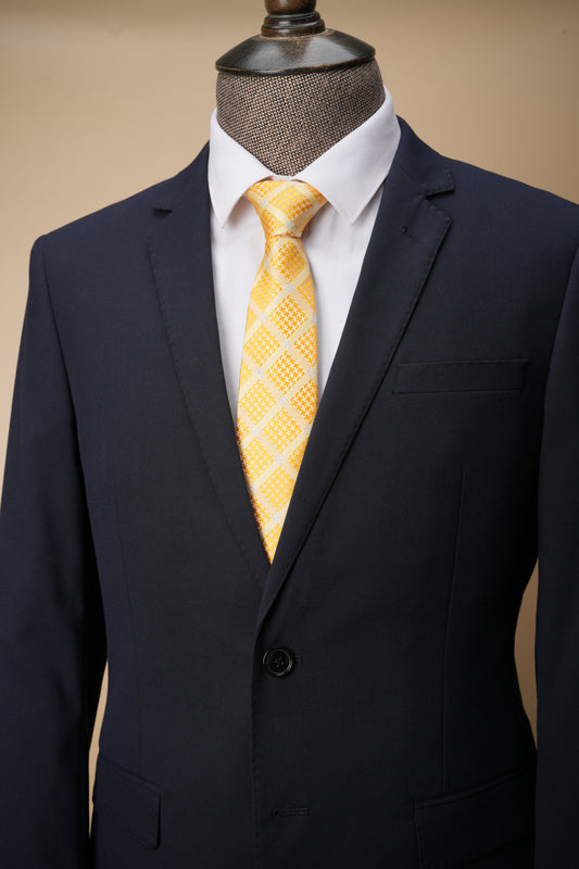 Yellow patterned tie on a mannequin with a dark suit jacket.