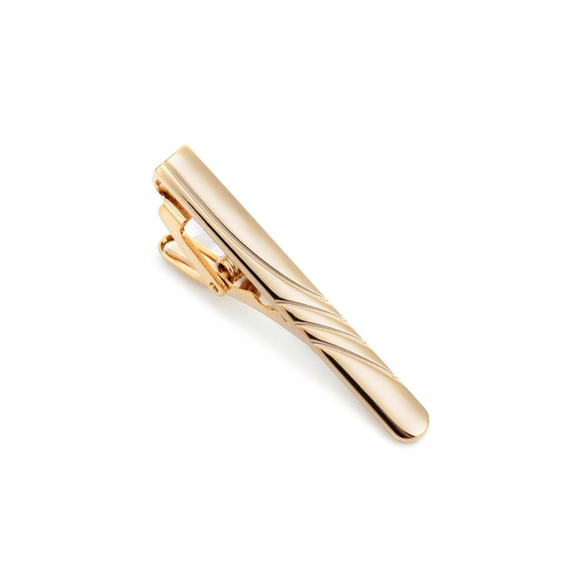 gold tie bar with spiral groove design on white background.