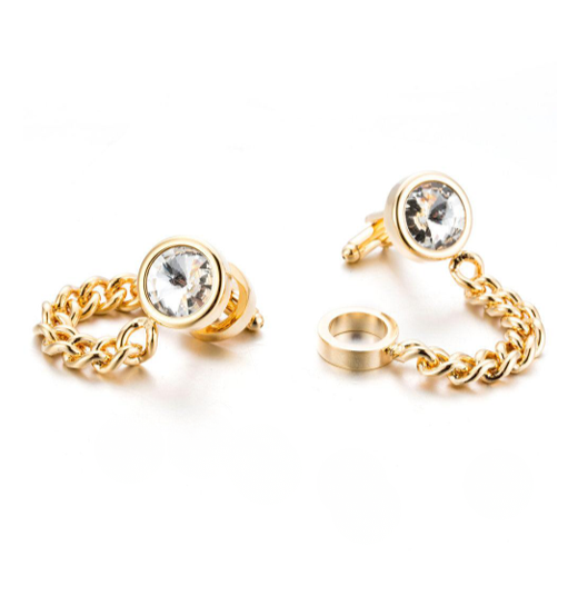 Gold chain cufflinks with clear gemstones on a white background