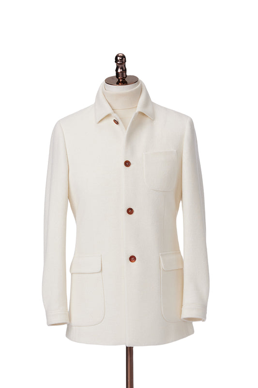 White jacket with brown buttons on a mannequin against a white background