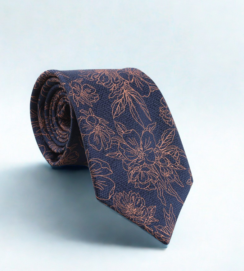 Floral patterned navy tie on a light blue background