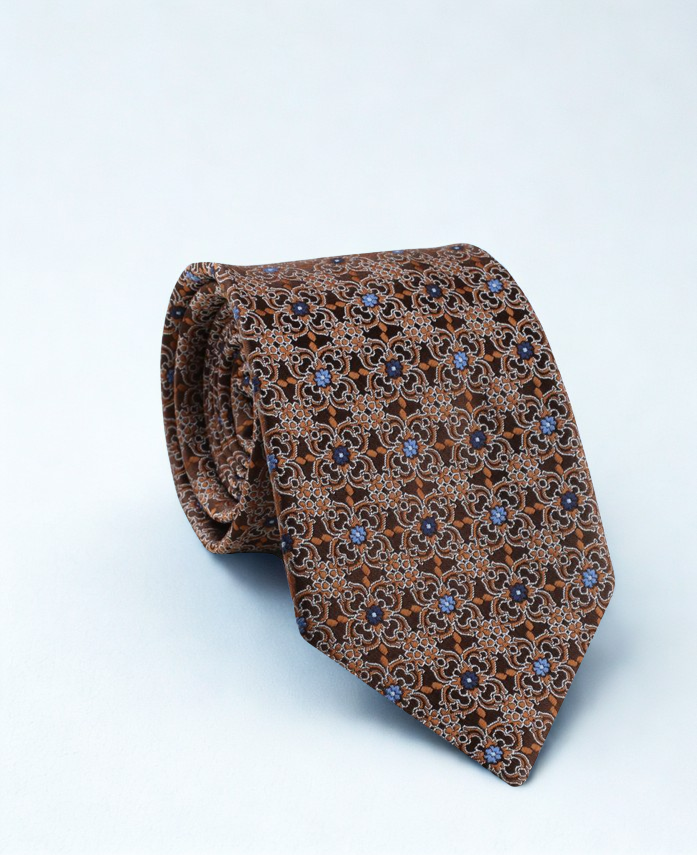 Brown patterned tie on a light blue background