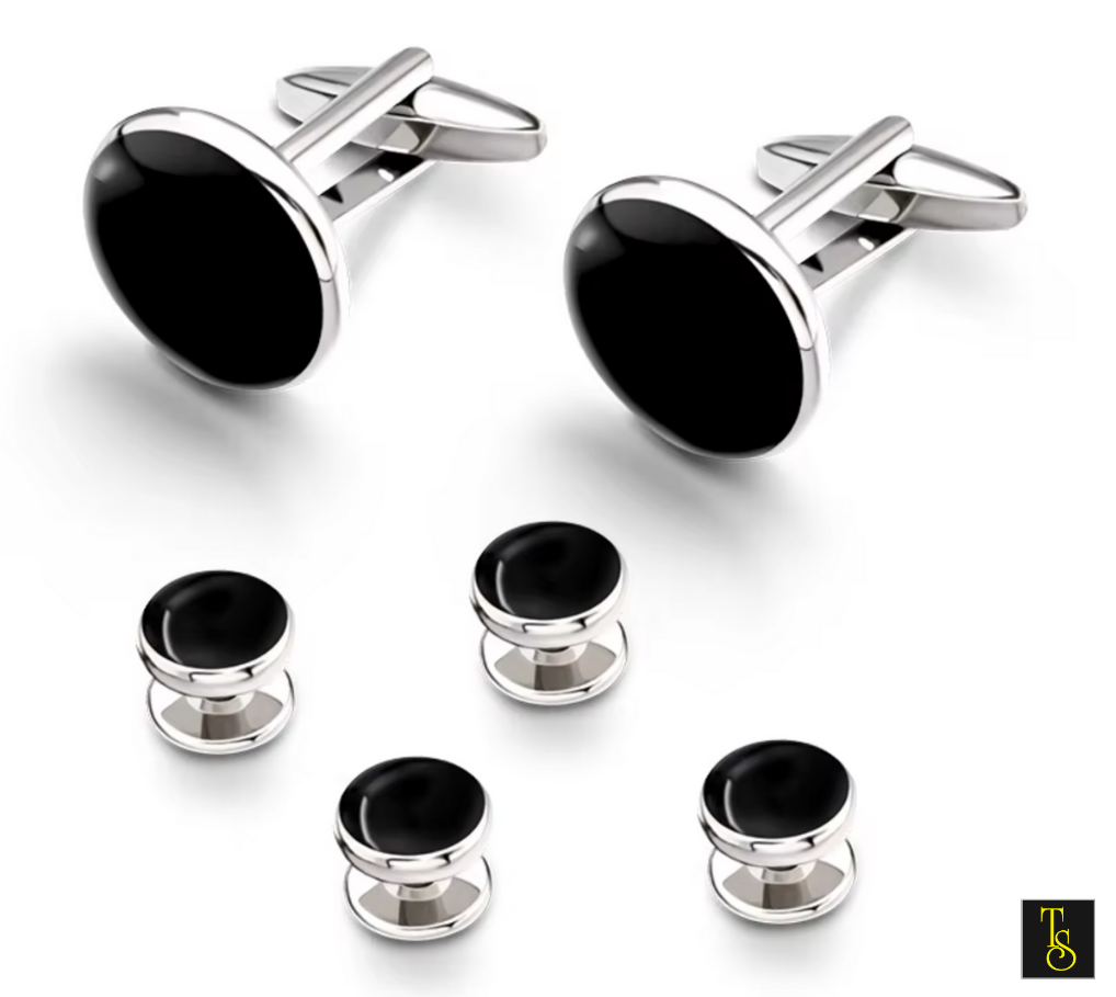 Set of black and silver cufflinks on a white background