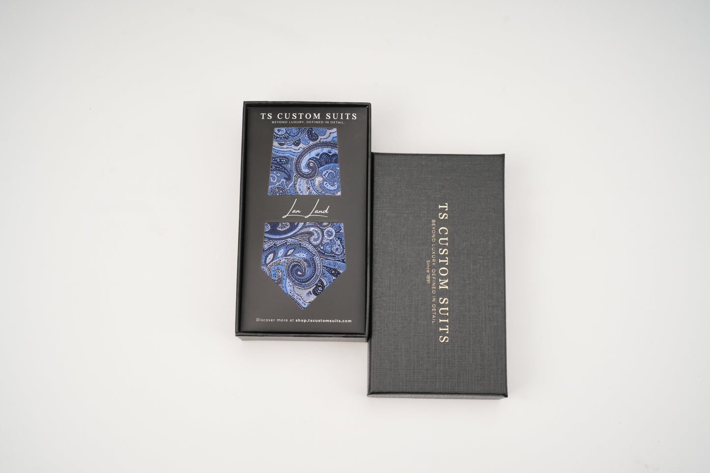Gray box with blue paisley tie design and 'TS Custom Suits' branding on a white background