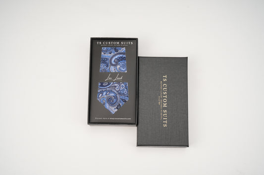 Gray box with blue paisley tie design and 'TS Custom Suits' branding on a white background