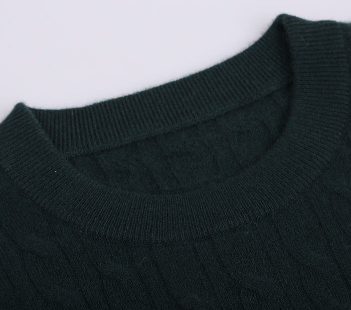 Close-up of a dark green cashmere sweater collar on a white background