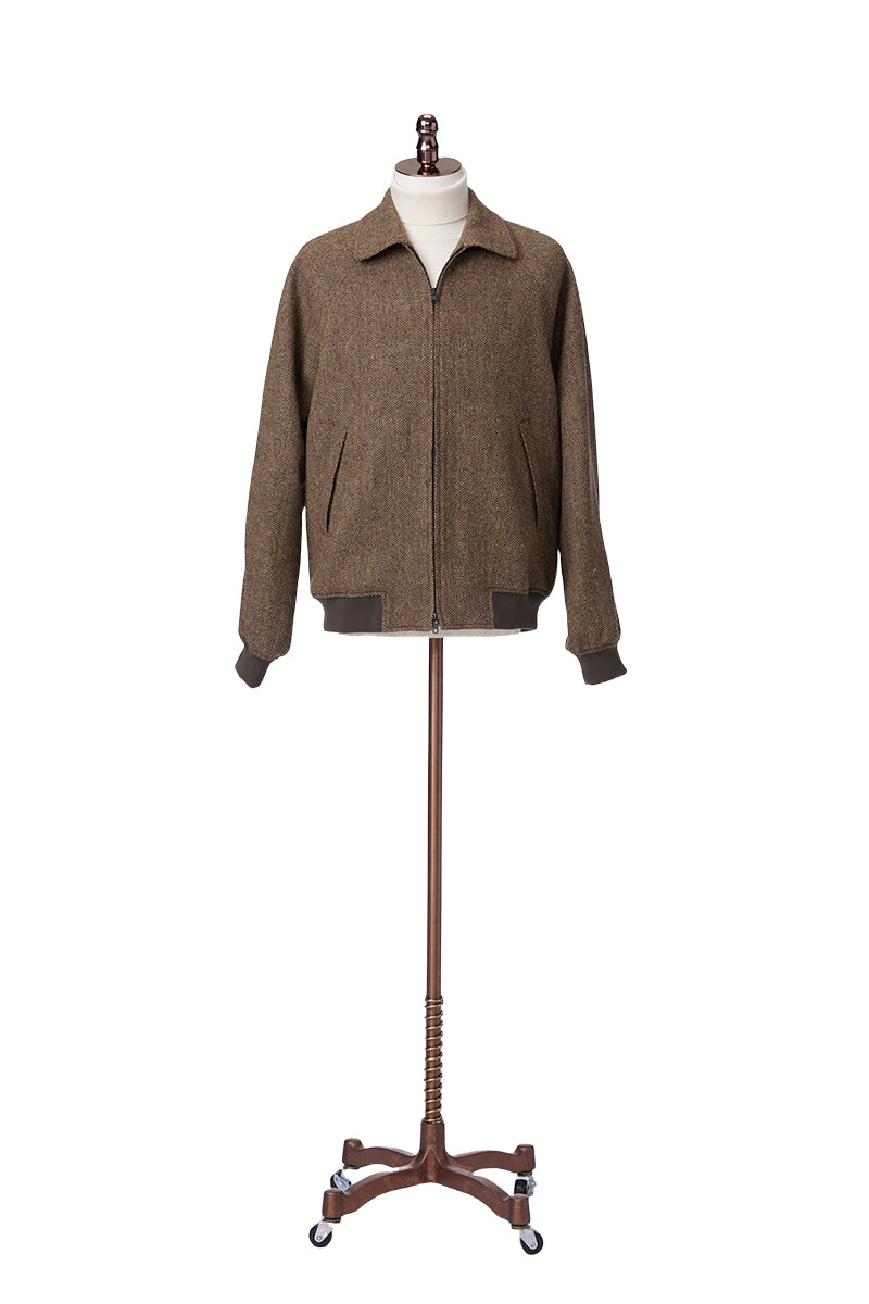 Brown jacket on a wooden mannequin stand against a white background