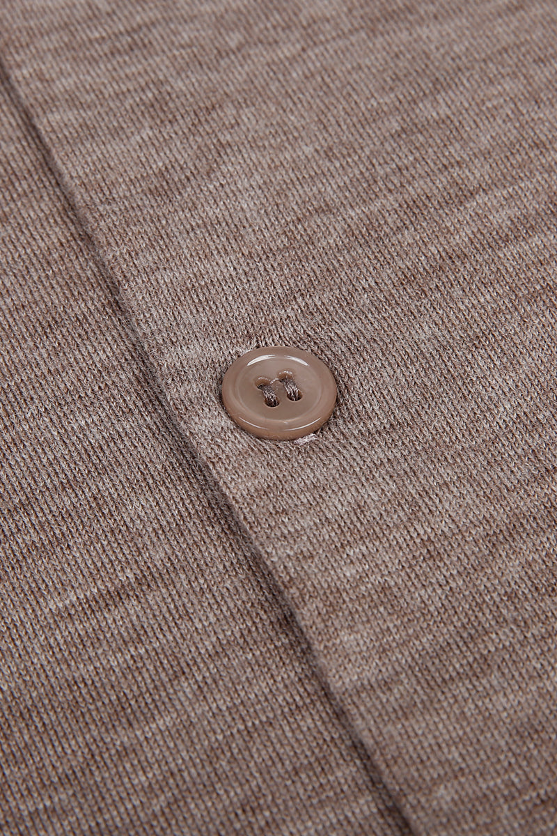 Close-up of a button on a textured brown wool