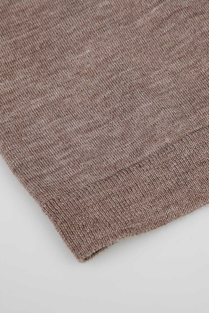 Close-up of a brown wool fabric on a light gray background