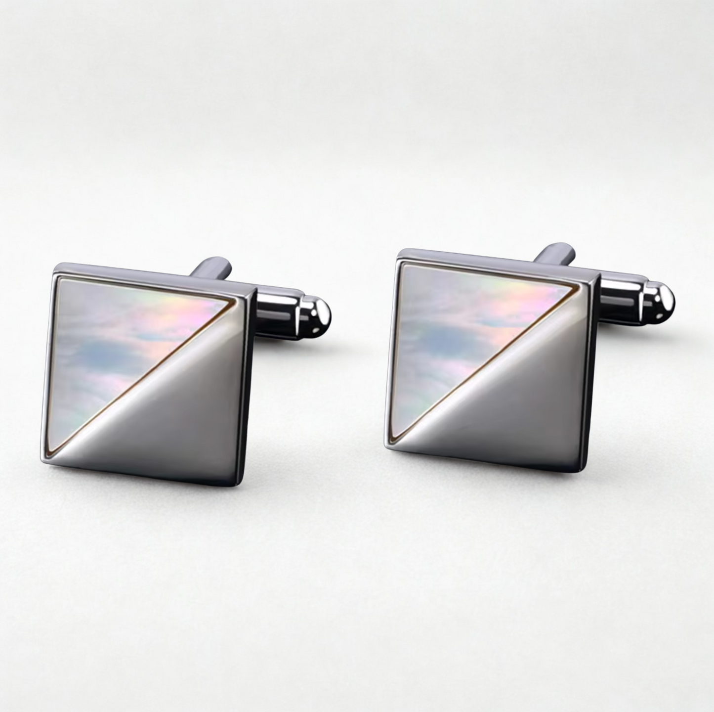 Pair of square cufflinks with metallic finish on a white background