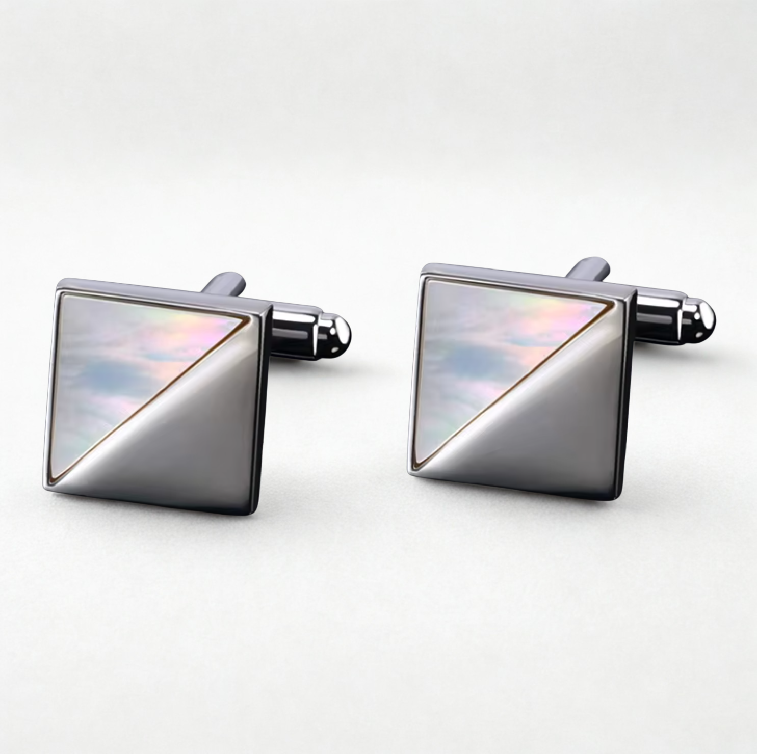 Pair of square cufflinks with metallic finish on a white background