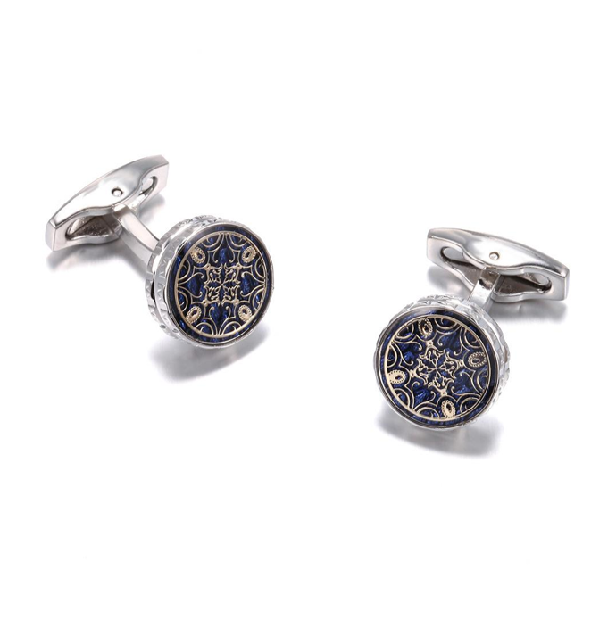 Pair of cufflinks with intricate design on a white background