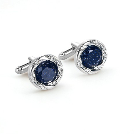 Pair of silver cufflinks with blue gemstones on a white background