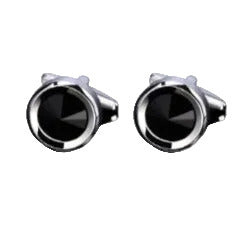 Black cufflinks with silver borders on a white background