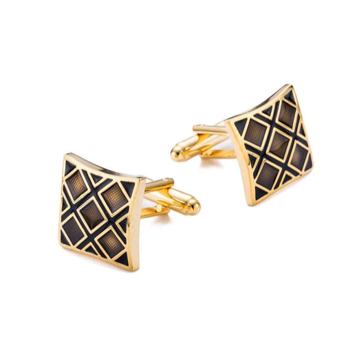 Gold and black geometric patterned cufflinks on a white background